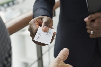 man hands out business card